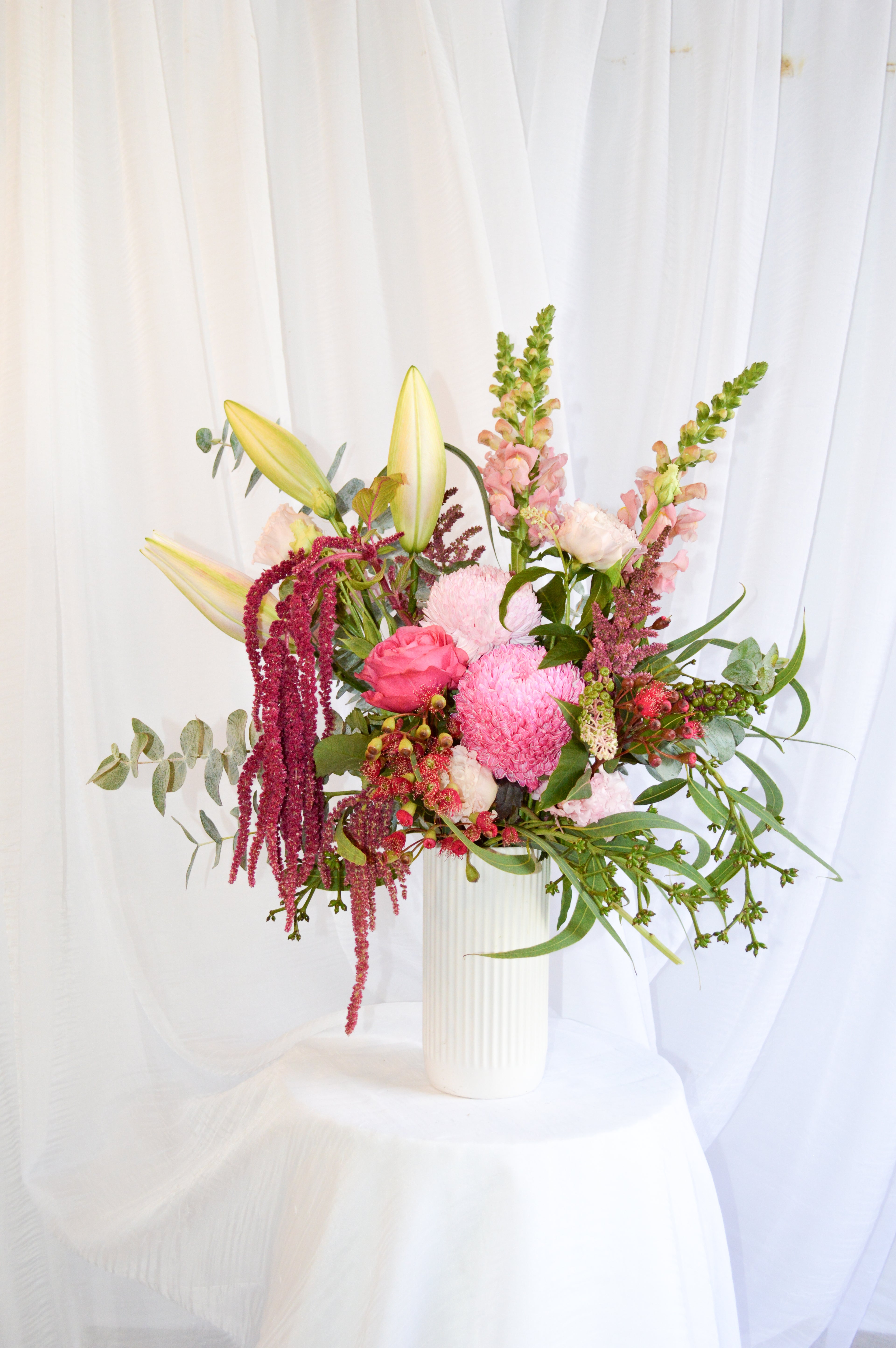 Pink themed bouquet featuring roses, disbuds, snapdragons, Lillies, amaranthus and green gum.